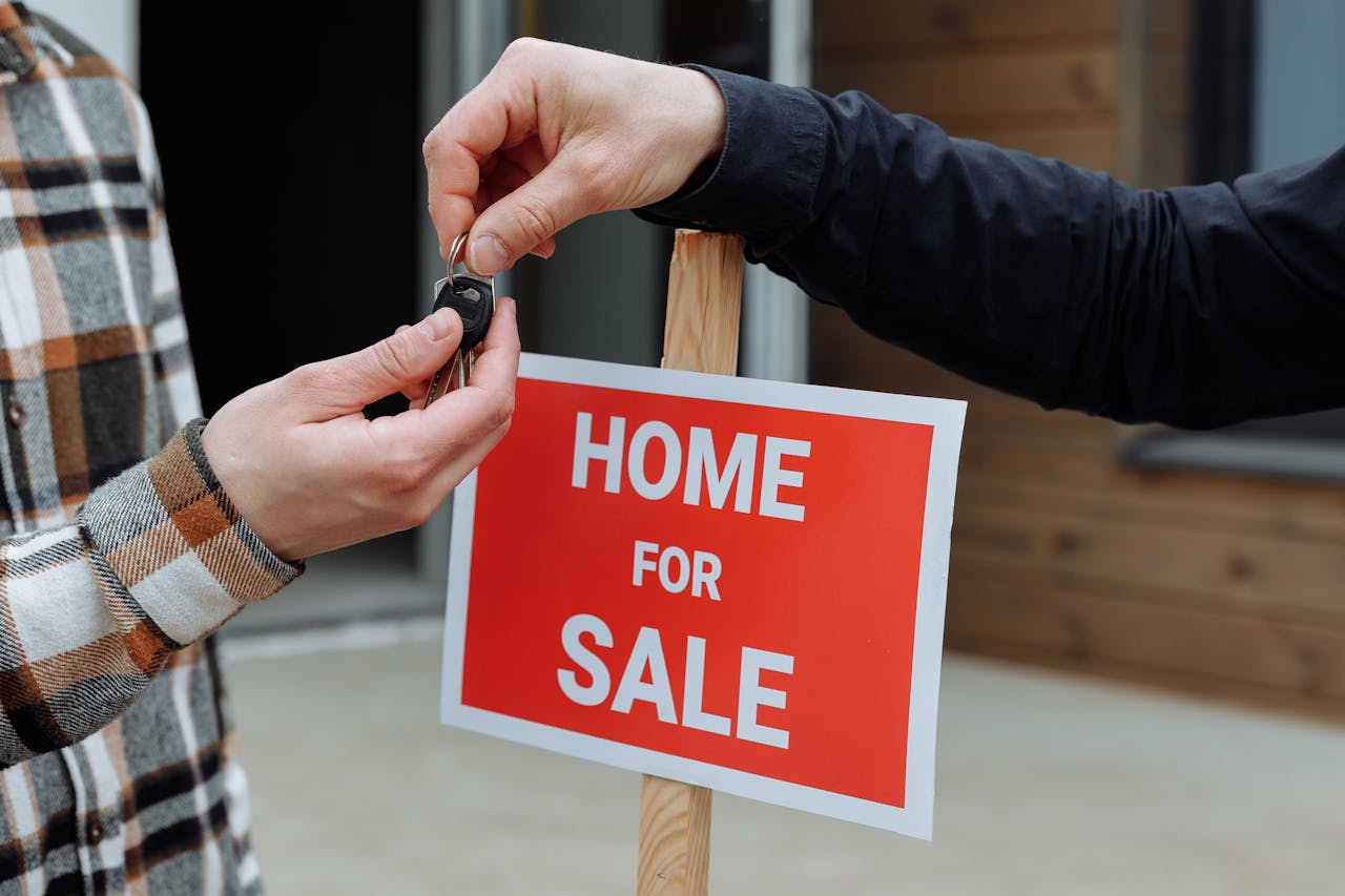 why-choose-us Close-up of a home for sale sign with people exchanging keys.